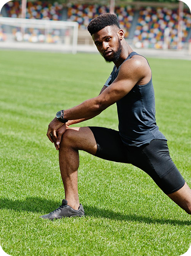 Athlete in sportswear doing stretching exercises in a stadium