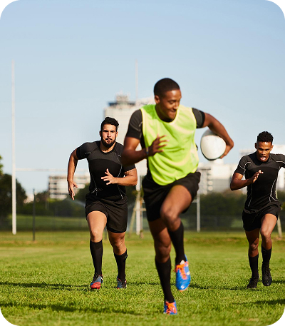 Player running with a football in hand on the ground