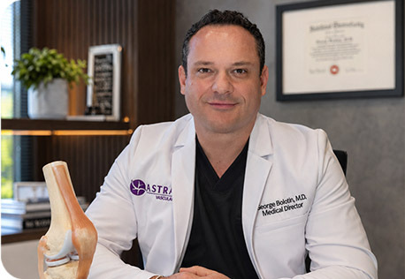 Dr. George Bolotin with knee model at Astra Knee Pain Center
