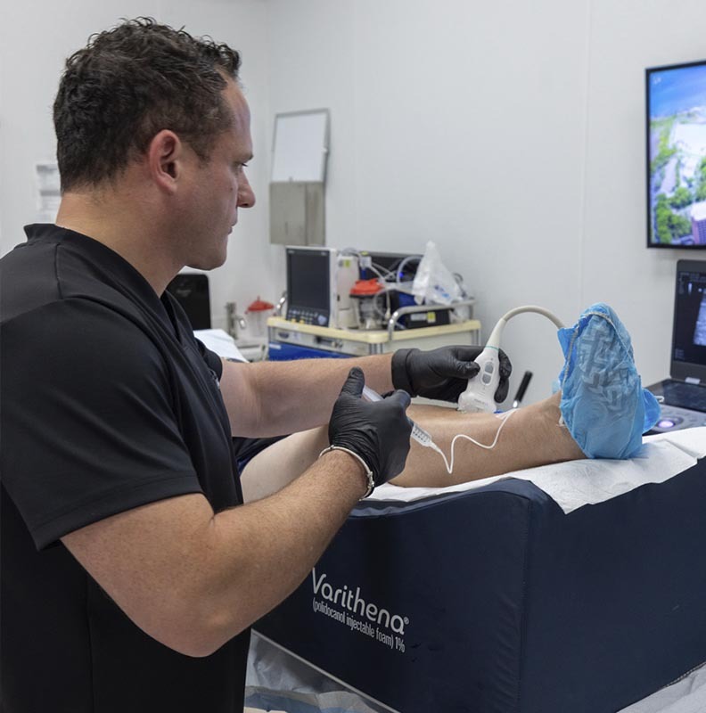 Dr. George Bolotin performing a non-surgical genicular artery embolization (GAE) procedure for chronic knee pain at Astra Knee Pain Center.