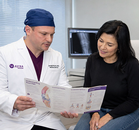 George Bolotin MD reviewing knee pain treatment options with a patient at Astra Knee Pain Center