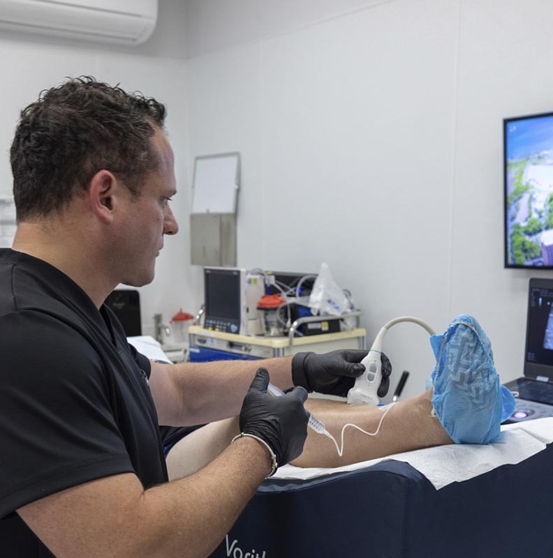 Dr. George Bolotin performing a circulation assessment before GAE for knee pain
