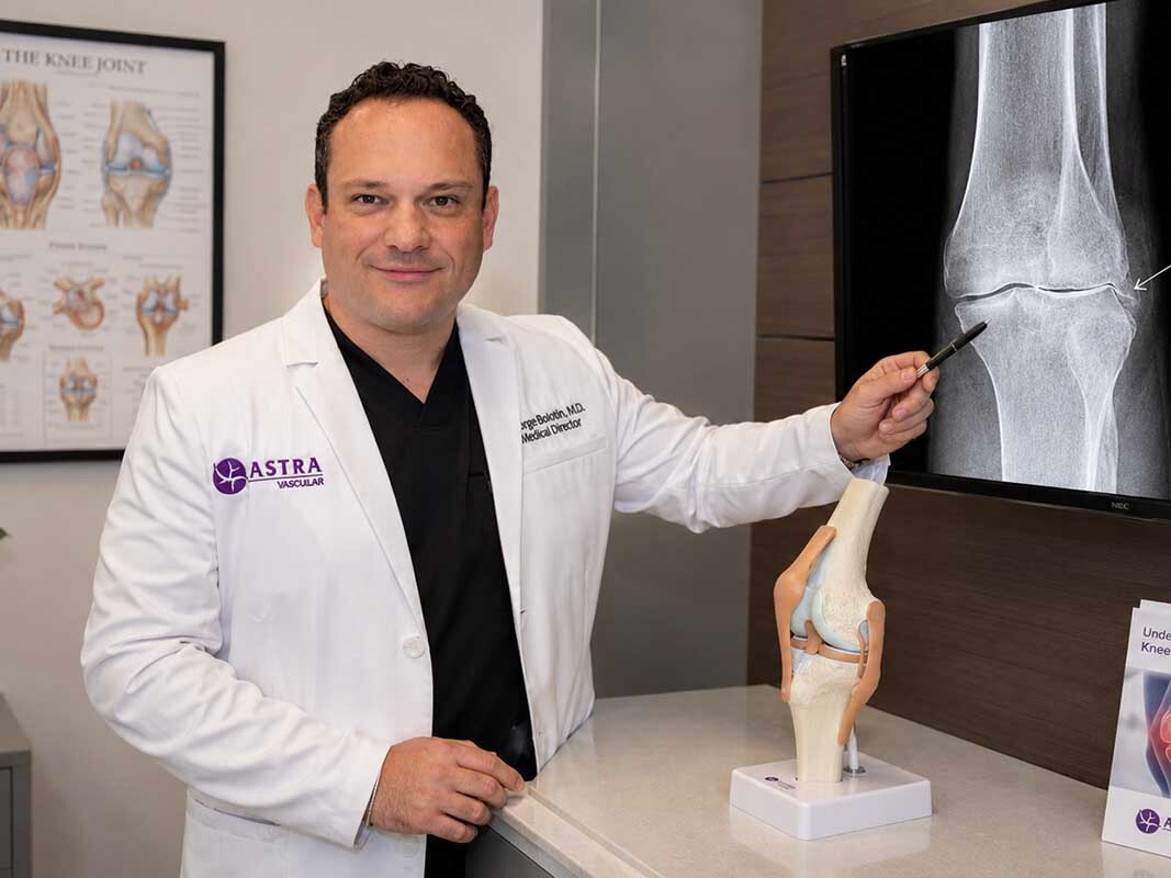 Dr. George Bolotin, knee pain specialist at Astra Knee Pain Center, evaluating a patient for genicular artery embolization