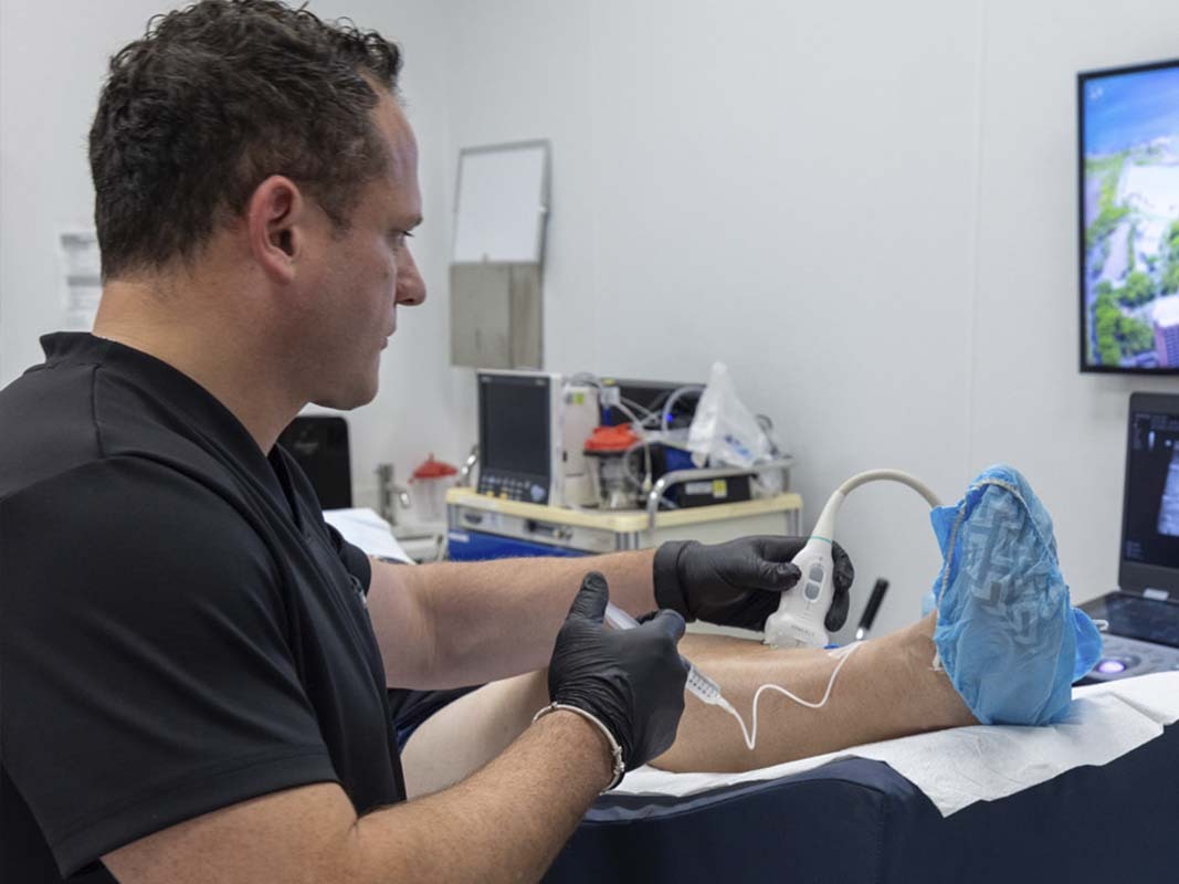 Dr. George Bolotin performing image-guided genicular artery embolization for knee pain at Astra Knee Pain Center in Brooklyn, NY.